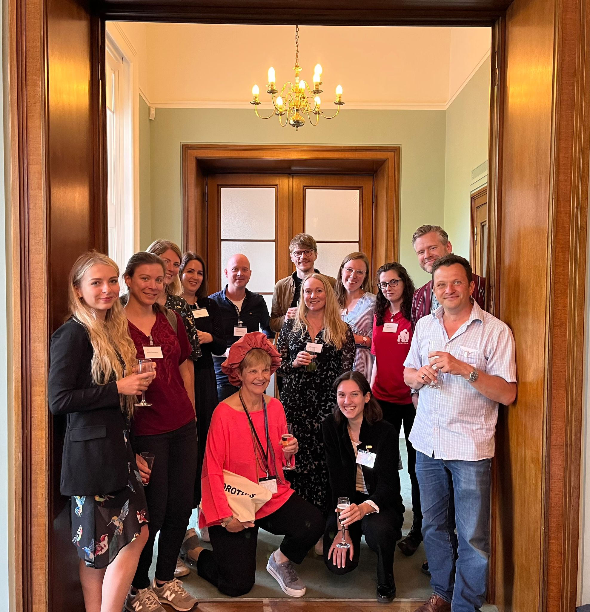 A picture of attendees at the Dorothy Bishop Festschrift, held at the Royal Society in 2022. Those pictures include the authors of this blog, including Dorothy herself sporting a fantastic hat.  